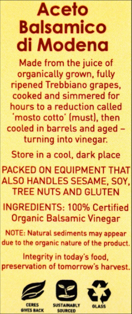 Label for Aceto Balsamico di Modena vinegar with text and symbols on a yellow background