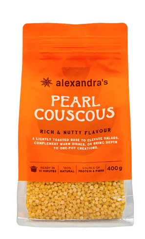 A package of Alexandra's Pearl Couscous with yellow couscous inside on a white background