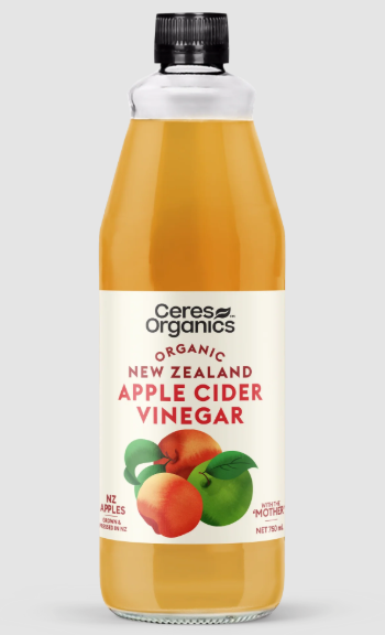 Bottle of Ceres Organics New Zealand Apple Cider Vinegar on a light gray background