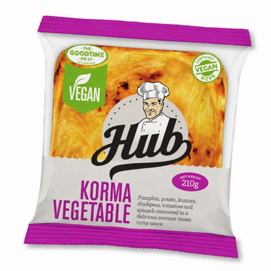 A packaged Hub Gourmet Vegan Korma Vegetable Pie, featuring a white and purple bag with a yellow-orange food photo and green vegan badges. A blue frozen icon is overlaid in the top left.