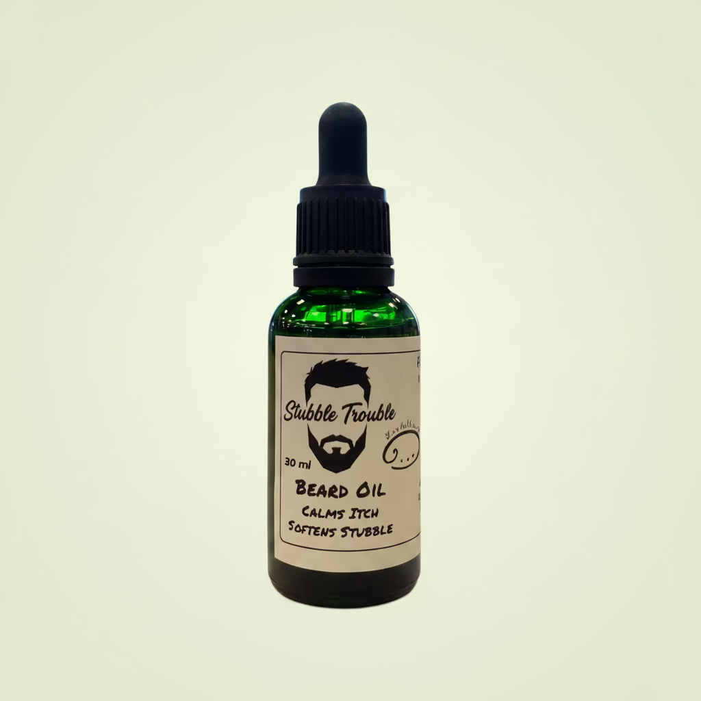 Bottle of 'Stubble Trouble' beard oil on a wooden table with a blurred indoor background