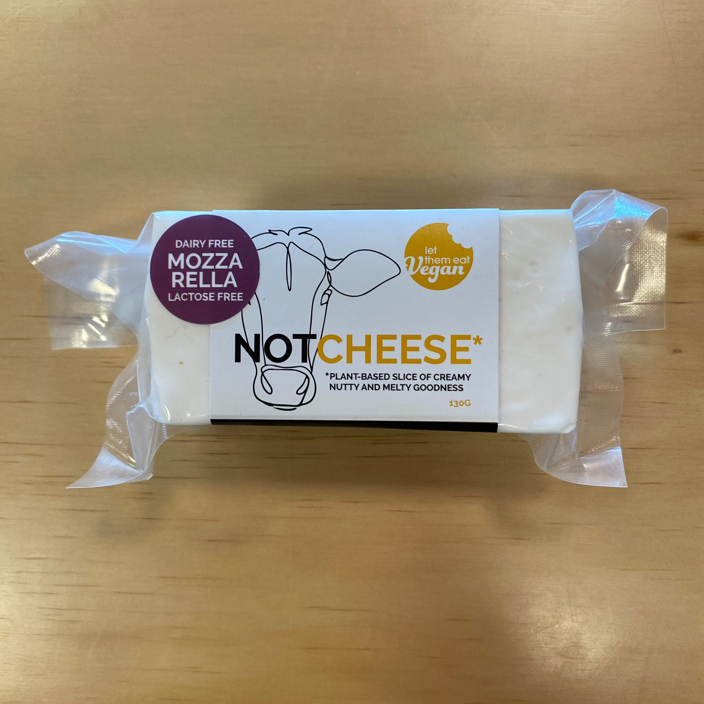 Block of Let Them Eat Vegan Mozzarella Vegan Cheese on a wooden surface