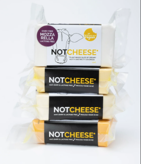 Stack of NLet Them Eat Vegan Mozzarella Block with packaging on a white background