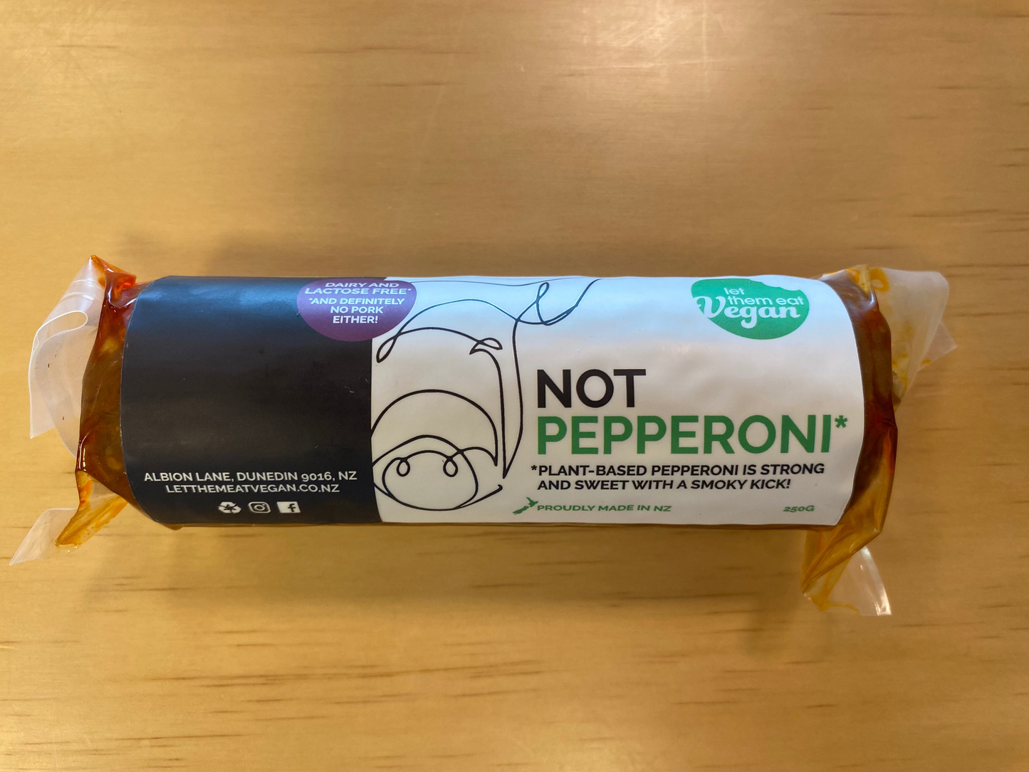 Packaged Let Them Eat Vegan 'Not Pepperoni' on a wooden surface