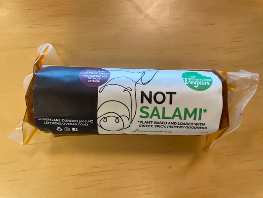 Packaged Let Them Eat Vegan 'Not Salami' on a wooden surface