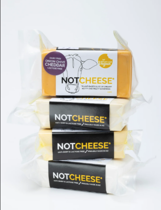 Stack of Let Them Eat Vegan Onion & Chive Cheddar Block on a white background