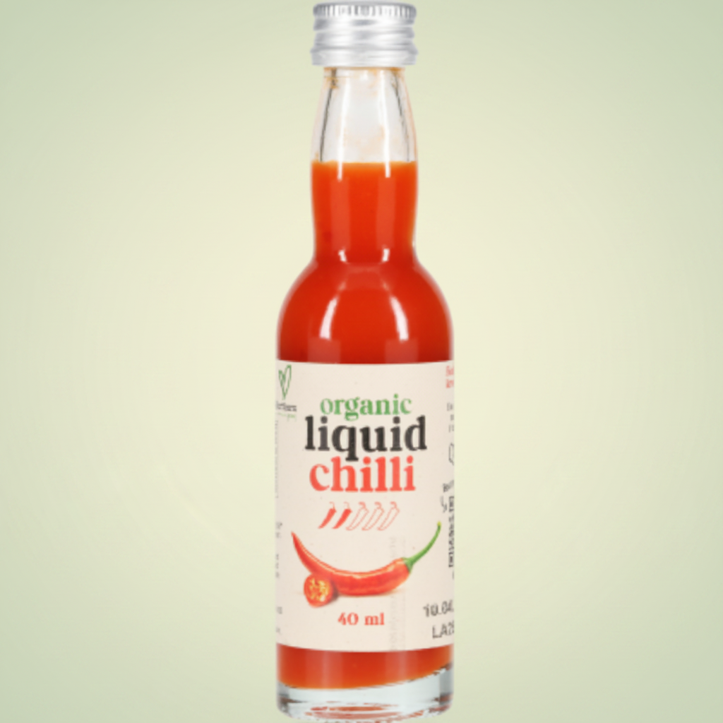 Bottle of organic liquid chilli with a white label on a light gray background