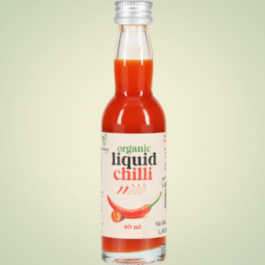 Bottle of organic liquid chilli with a white label on a light gray background