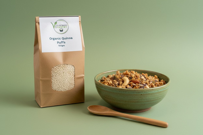 A 150g bag of Organic Quinoa Puffs by PlantBased Pantry, shown on a wooden counter with a store interior in the background.