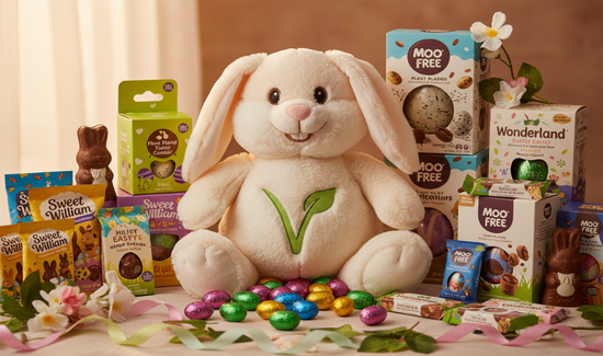The Plantbased Pantry Easter Bunny surrounded by Vegan Easter-themed products including chocolate eggs and boxes on a decorative table.