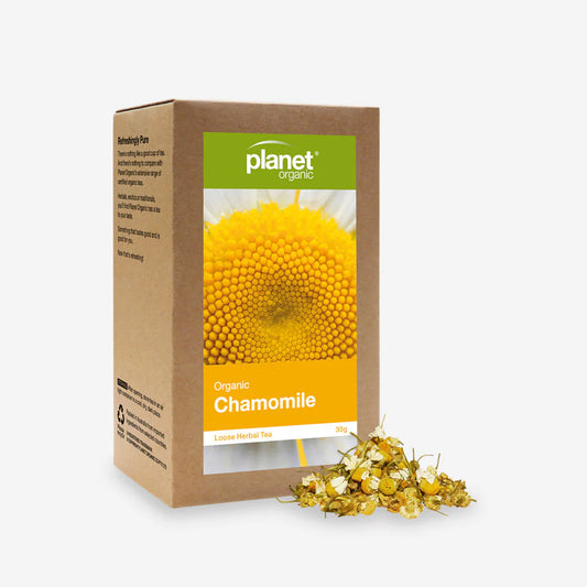 Planet Organic chamomile tea packaging with loose chamomile flowers on a white background
