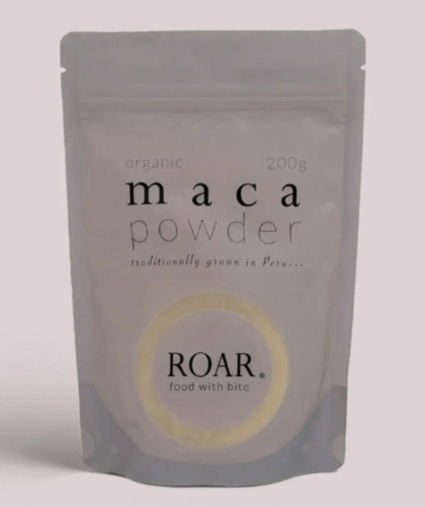 Package of maca powder by ROAR on a light pink background