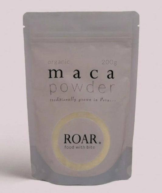 Package of maca powder by ROAR on a light pink background