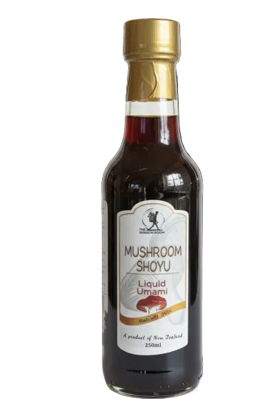 Bottle of Mushroom Shoyu with a gold cap on a white background