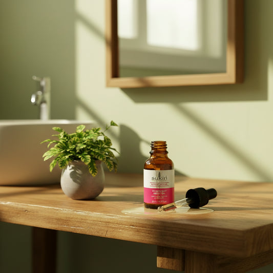 Sukin Overnight Relief Oil bottle with dropper on a beige background